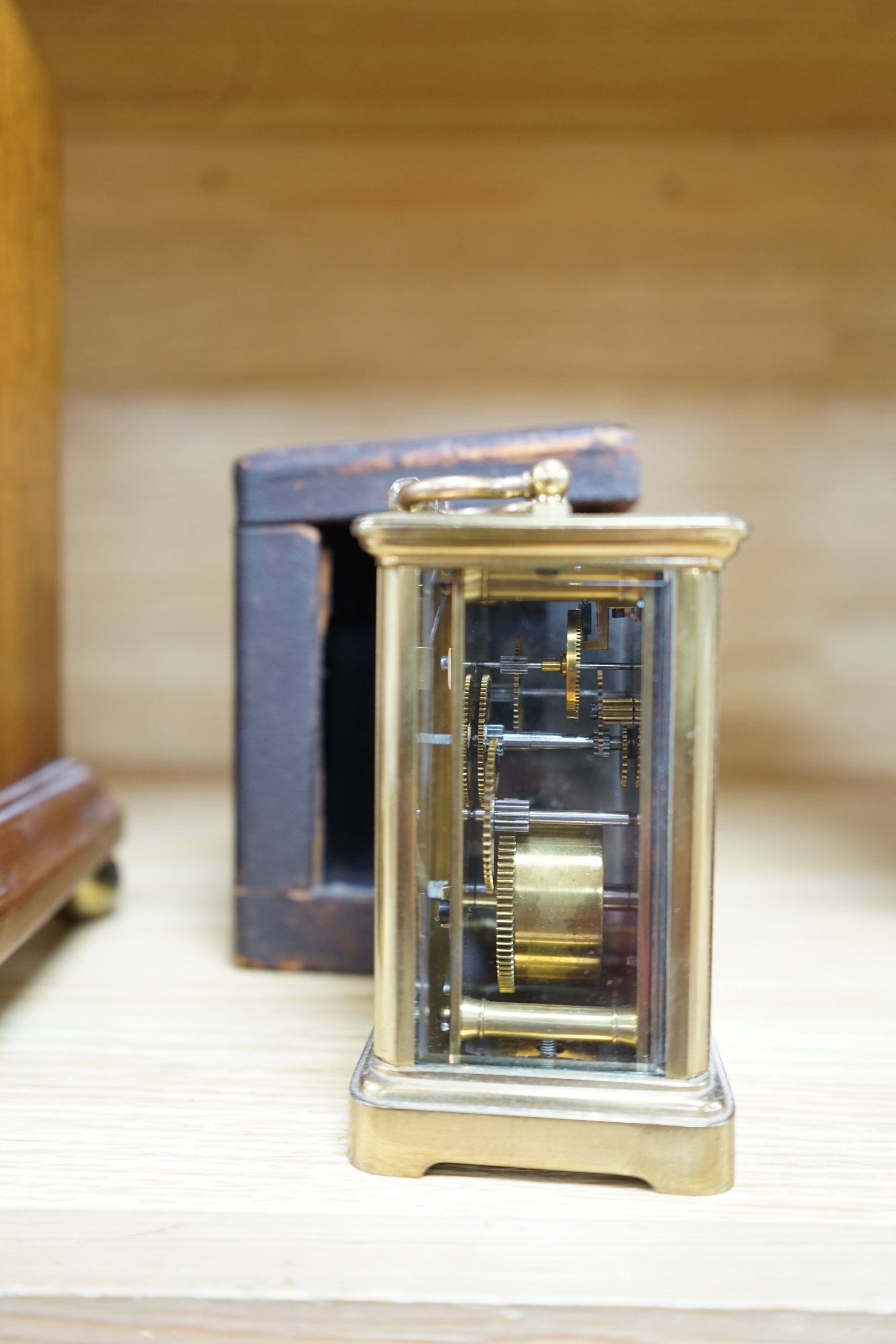 A cased brass carriage timepiece and a dome topped Edwardian mantel clock striking on a coiled gong, backplate stamped BTG, 29.5cm (2) Condition - fair to good.